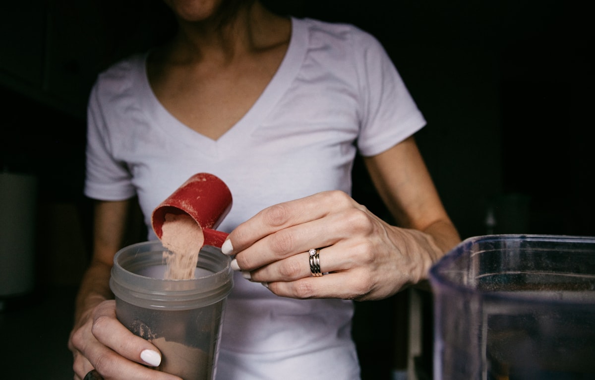 Woman tracking workout progress in fitness journal